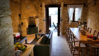 a living room with a couch and a table and a fireplace at Haven in Limassol