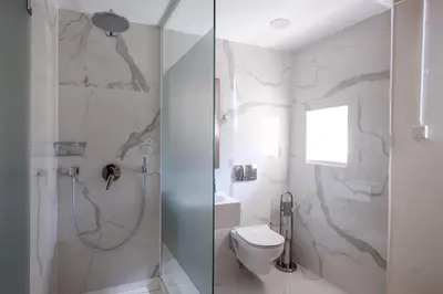 a bathroom with a shower and a toilet at Limassol Old Town Mansion in Limassol