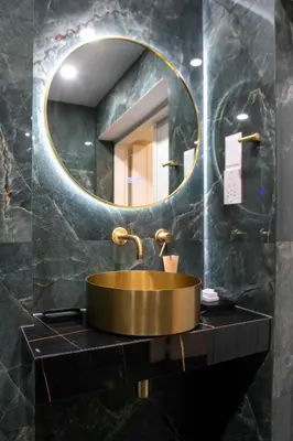 a bathroom with a gold sink and a mirror at Limassol Old Town Mansion in Limassol