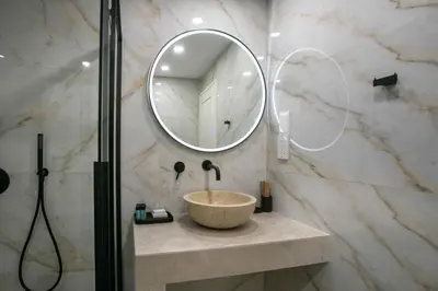 a bathroom with a bowl sink and a mirror at Limassol Old Town Mansion in Limassol