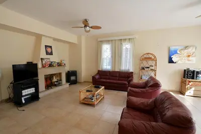 a living room with two couches and a tv at Villa Daryah Sirina Bay in Protaras