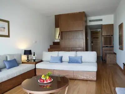 a living room with a couch and a table at Sunrise Pearl Hotel & Spa in Protaras