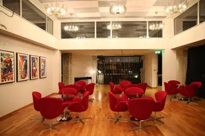 a room with red chairs and tables in it at Altius Boutique Hotel in Nicosia