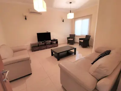 a living room with a couch and a tv at Orchard Blossom Private Villa With Pool in Phrenaros