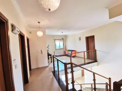 a hallway with a staircase in a house at Orchard Blossom Private Villa With Pool in Phrenaros