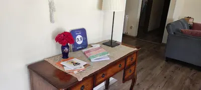 a table in a living room with a lamp on it at Roses Villa in Trimiklini