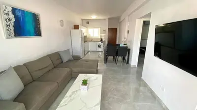 a living room with a couch and a television at Napa Court 2 in Ayia Napa