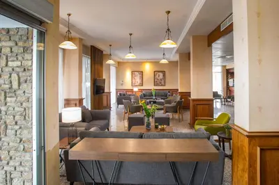 a lobby with couches and tables and chairs at Kapetanios Limassol Hotel in Limassol