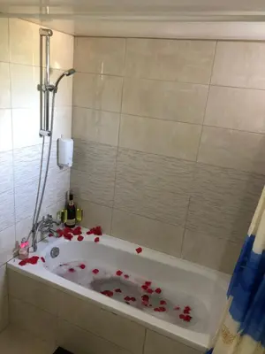 a bathroom with a bath tub covered in red roses at Lucky 2 in Paralimni