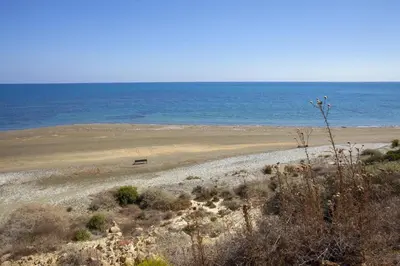 an empty beach with the ocean in the background at Faros BeachFront Villa in Pervolia