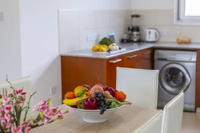 a bowl of fruit on a table in a kitchen at Faros BeachFront Villa in Pervolia