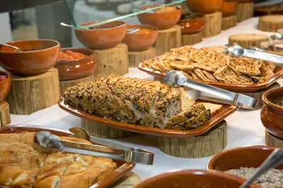 a table filled with different types of food at Golden Coast Beach Hotel in Protaras