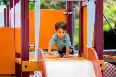 a little boy is playing in a play structure at Golden Coast Beach Hotel in Protaras