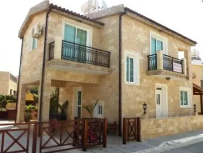 a large brick building with balconies on a street at Philippou Beach Villas & Apartments in Larnaka