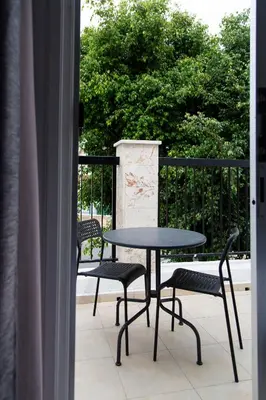 a table and chairs sitting on a balcony at Summer's Hotel Apartments in Ayia Napa