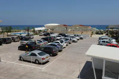 a parking lot with a bunch of cars parked at Polyxenia Isaak Luxury Villas and Apartments in Protaras