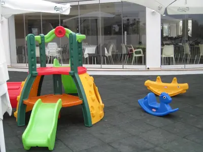 a set of playground equipment in front of a building at Polyxenia Isaak Luxury Villas and Apartments in Protaras