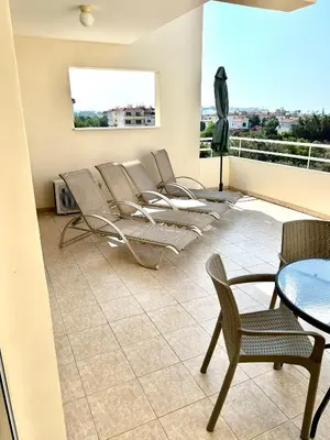 a room with chairs and a table and a balcony at Nissi Elena A11 in Ayia Napa