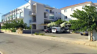 a white van parked in front of a building at Cosy apartment in a luxury resort in Paralimni
