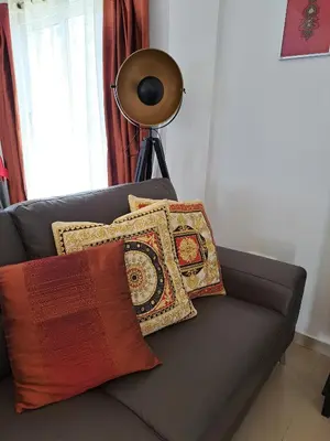 a black couch with pillows on it with a lamp at Anasta villa in Protaras