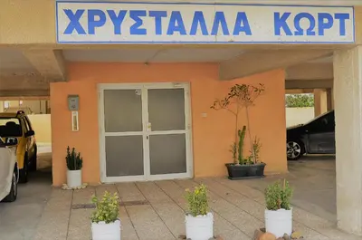 a building with a door and potted plants in front of it at LIRA in Larnaka