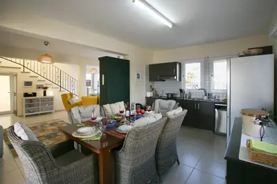 a kitchen and dining room with a table and chairs at Villa Carmel in Ayia Napa