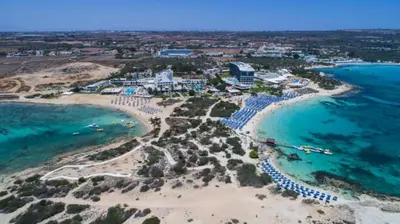 an aerial view of a resort on the beach at Villa Carmel in Ayia Napa
