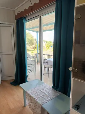 a room with a table and a sliding glass door at Mazotos beach house in Mazotos