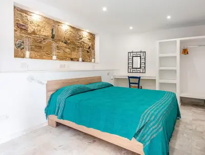 a bedroom with a bed with a green blanket at Cyprus Villages - Hotel & Restaurant - Central Location - Bed & Breakfast With Access To Pool And Stunning Views in Tochni