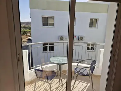 a balcony with a table and chairs and a view at Oceania Bay Village in Pyla