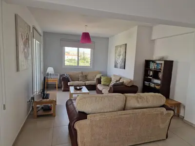 a living room with two couches and a pink ceiling at Oceania Bay Village in Pyla