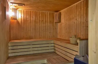 a wooden sauna with a bench in a room at Oceania Bay Village in Pyla