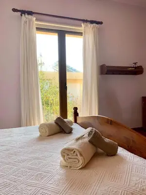 a bedroom with a bed with towels on it at Rustic House in Xylophaghou
