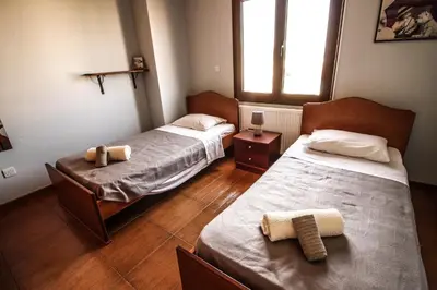 two beds in a room with two towels on them at Rustic House in Xylophaghou