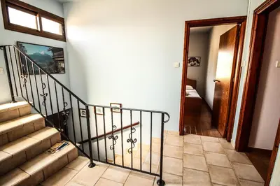 a hallway with a staircase and a door to a room at Rustic House in Xylophaghou