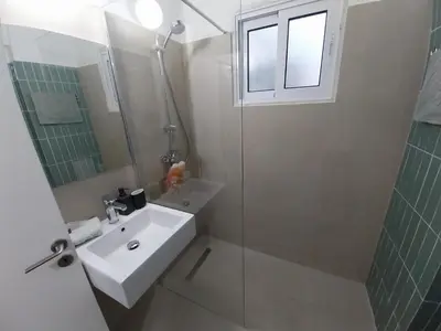 a bathroom with a sink and a glass shower at Yippee!(Perfect Location) in Larnaka