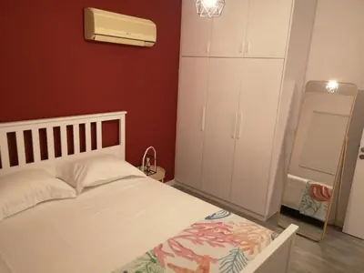 a bedroom with a white bed and a white cabinet at Yippee!(Perfect Location) in Larnaka