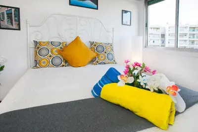 a bedroom with a large white bed with flowers on it at Poseidon Boutique Apartment 2 in Limassol