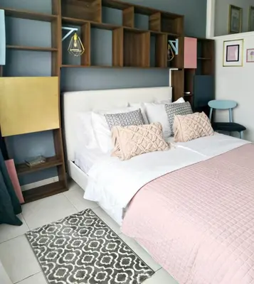 a bedroom with a large white bed with pink sheets at Cozy Getaway in Nicosia in Yukarı Lakatamya
