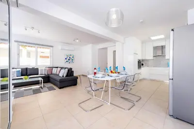 a living room with a table and a couch at Villa Elaine in Paralimni