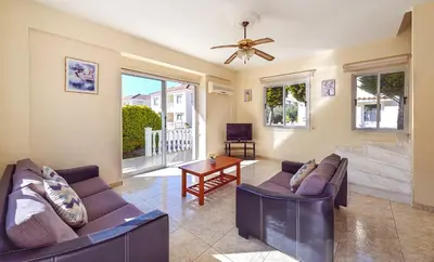 a living room with two couches and a table at Hadjios Valley in Mazotos