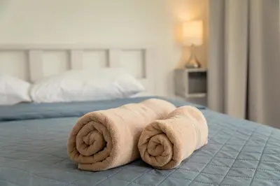 a rolled up towel on top of a bed at Andriana City Centre Flat in Larnaka