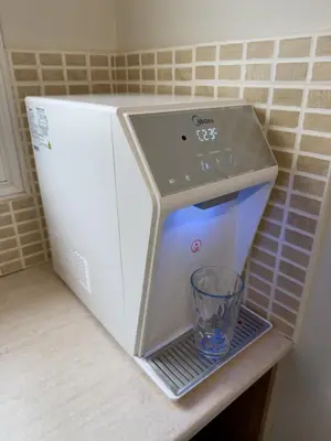 a small refrigerator with a glass on a shelf at ♥ Sunny&Cozy Family Apartment ★ Walk to the Beach☼ in Paralimni