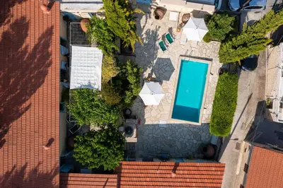 an overhead view of a swimming pool in a parking lot at Villa Avgoustis in Pachna