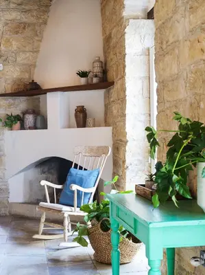 a living room with a table and a fireplace at Villa Avgoustis in Pachna