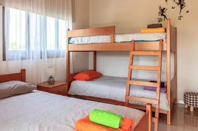 a bedroom with two bunk beds and a bed at BerryRose Villa in Pervolia