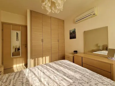 a bedroom with a bed and a dresser and a mirror at Lovely Bedroom in shared apartment Oroklini in Voroklini