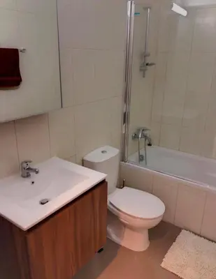 a bathroom with a toilet and a sink and a tub at Mythical Sands Luxury Apartment in Paralimni