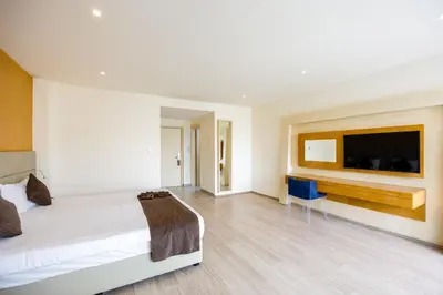 a hotel room with a bed and a television at Melpo Antia Hotel & Suites in Ayia Napa