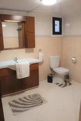 a bathroom with a sink and a toilet at Salt Lake Town House in Larnaka